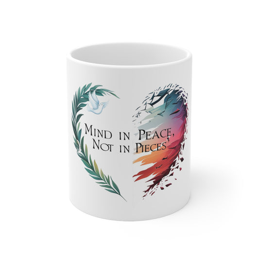 Start your day with a comforting message of tranquility and wholeness with our "Mind in Peace, Not in Pieces" inspirational mug. This unique design features a beautiful heart, half formed by serene olive branches and a dove symbolizing peace, and the other half by vibrant, soaring wings that seem to break free. It's a powerful visual reminder to nurture your inner peace and embrace resilience.

Perfect for your morning coffee, evening tea, or any hot beverage, this durable ceramic mug is designed for daily.